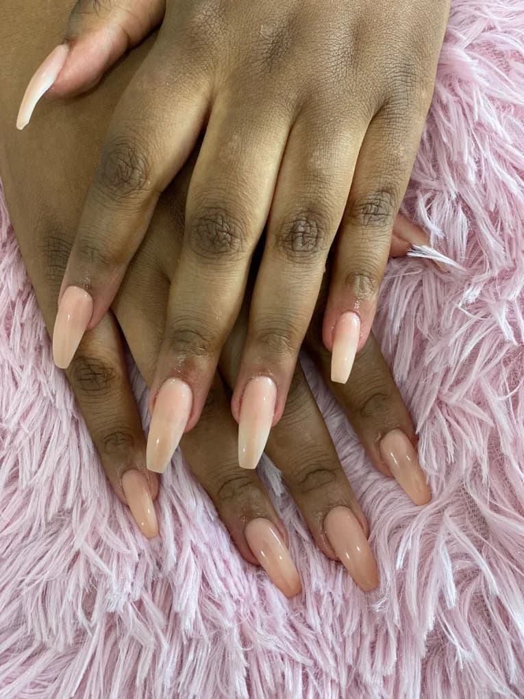 Coffin-shaped nails in a nude to white ombre.