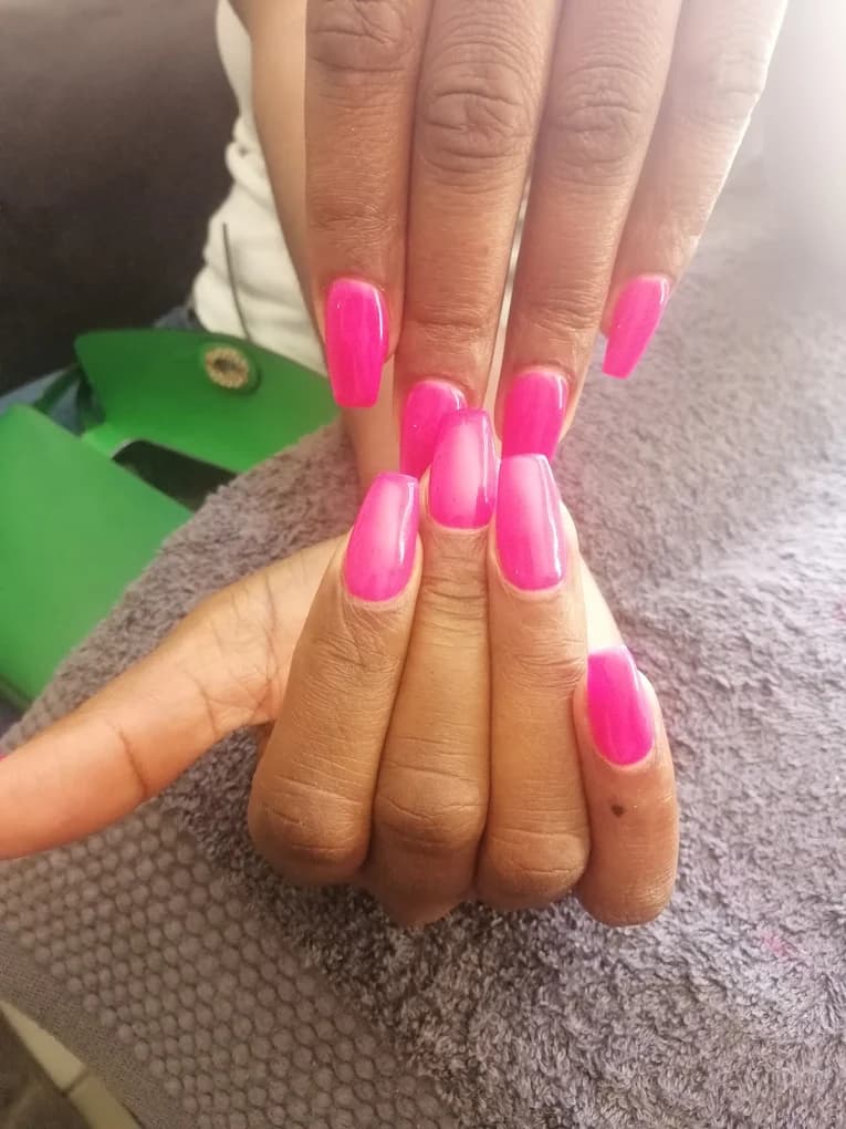 Square nails in a bright hot pink.