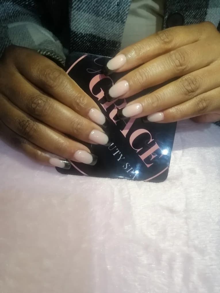Short nude nails in a soft squoval shape with a glossy finish.